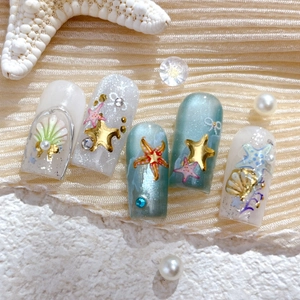 Deep sea shell press-on nails with 3D starfish, pearls, and golden embossed glitter accents