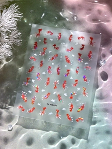 Macro detail of Chinese koi fish nail art stickers with iridescent shells and floral patterns