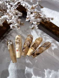 Macro detail of Chinese style lotus nail art stickers with ink painting and pearl accents