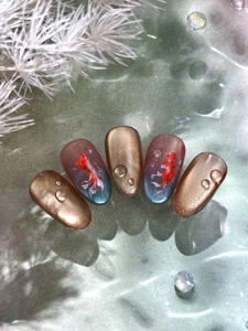 Detail of koi fish nail art with 3D water drops and cat-eye metallic finish
