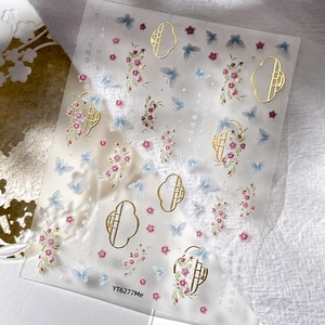 Golden butterfly nail art stickers with traditional Chinese patterns and floral designs