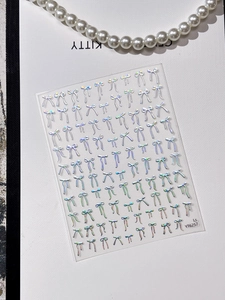 3D laser silver bow nail stickers with pearl necklace detail on white background