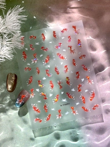 Detail of koi fish and butterfly nail art stickers with elegant shell shimmer effect