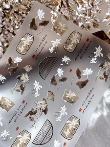 Macro detail of embossed white lotus nail stickers with traditional Chinese ink art design