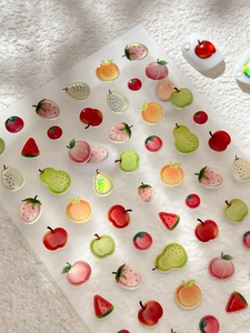 Detailed view of summer fruit nail stickers with glitter and 3D strawberry patterns