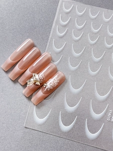 Detail of rose pink French tip coffin nails with white roses and 3D crystal accents