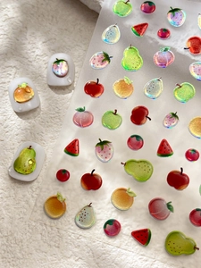Detailed view of 3D fruit nail stickers with pear, apple and strawberry 3D designs