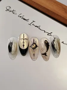 Detail view of gothic style nail stickers featuring gold cross and moon patterns