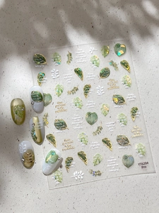 Close-up of YT6204 gold leaf nail stickers with tropical plant designs and elegant motifs