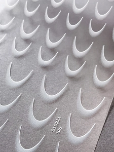 Macro shot of French gradient nail stickers with 3D embossed white crescent textures