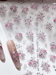 Detail of pink floral bouquet nail stickers with bows on long false nails