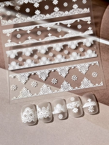 Detail view of 3D embossed white lace flower nail stickers with textured matte finish