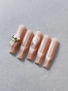 Detail of nude pink french press-on nails with white lace, pearls and 3D rhinestones