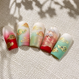 Chinese style press-on nails with red and green gradients, golden clouds, and pearls