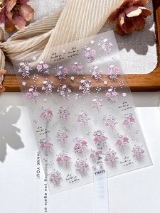 Macro detail of YT6233 embossed 3D nail stickers featuring pink bouquets and bows