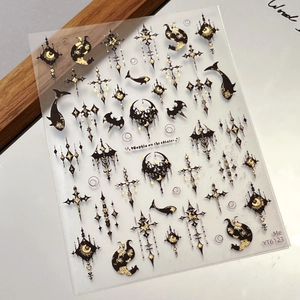 Gothic nail stickers with black and gold cross and moon patterns in 45-degree view