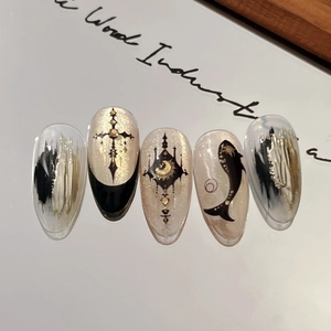 Gothic style shell luster press-on nails with golden glitter and vintage cross design