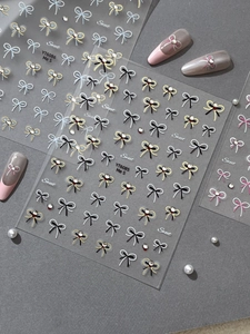 Detail of bow nail stickers with pearls and rhinestones on high-quality display sheet