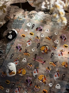 Detail of Halloween nail art stickers with ghosts, witches, and pumpkin patterns