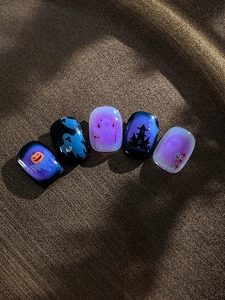 Detail of Halloween nail stickers featuring pumpkins, ghosts, and dark castle designs