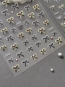 Detail view of YT6085 bow nail stickers with gold accents and pearl decorations
