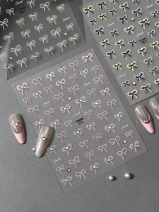 Detail of bow-knot nail stickers with crystal rhinestones and metallic gold foil finish