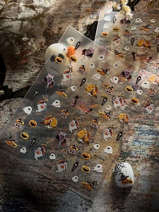 Detailed macro of 5D embossed Halloween nail stickers with pumpkins and ghost designs