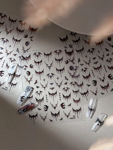 Detail of Gothic Halloween nail stickers featuring bats and spiders for dark manicures