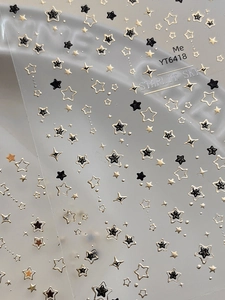 Macro detail of YT6418 Starlit Sky nail stickers with gold and black embossed stars