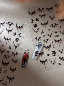 Close-up of Gothic Halloween nail stickers with bats, spider webs, and dark mystic elements