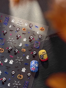 Detailed view of Halloween nail art stickers with reaper, pumpkin, and ghost motifs