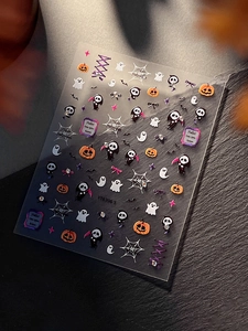 Detail of Halloween nail stickers featuring 3D pumpkin, ghost, and reaper designs
