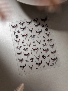 Macro detail of 6D Halloween nail stickers featuring 3D bats and colored eyeballs YT6531
