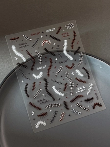 Detailed view of Halloween wound suture nail stickers with star motifs on a grey tray