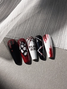 Detail of Halloween press-on nails with coffin shape, fake blood drops and spider web art