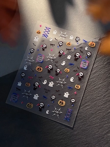 Detail of Halloween nail stickers with pumpkins, ghosts and reapers on dark rock surface