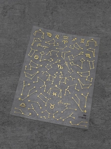 Detail of gold foil star sign nail stickers with celestial constellation line patterns