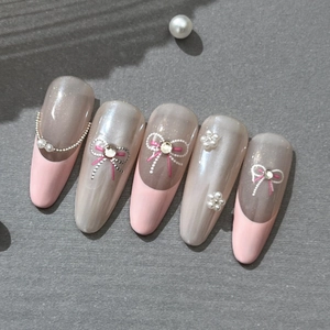 Long almond press-on nails with grey pearlescent base, pink French tips and pearl bows