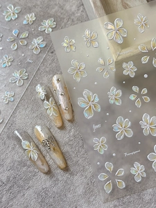 Detailed 5D relief plumeria nail stickers with pearlescent finish and floral accents