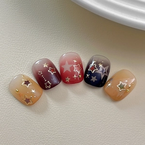 Star pattern gradient press-on nails in short square shape with gold foil star accents
