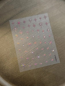 Detail of laser gold star nail stickers with rhinestones on transparent PET film