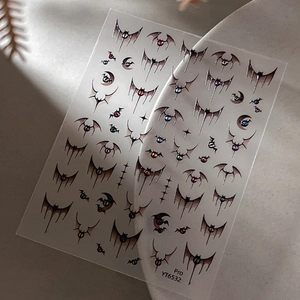 Gothic Halloween bat nail art stickers with colorful hearts and stars on gray stone