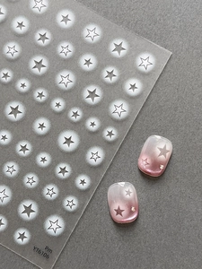 Close-up of star nail stickers with airbrush gradient effects on high-quality sheets