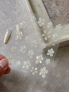 Detailed 5D embossed nail stickers featuring frangipani flowers and glitter accents