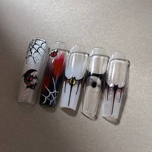Gothic Halloween press-on nails featuring dark bat, spider web and blood drip nail art designs