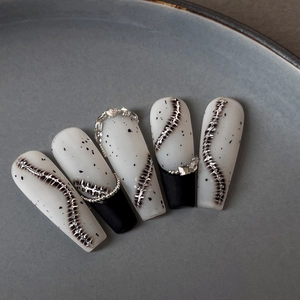 Minimalist long coffin nail tips with black ink spots and 3D silver spine metal relief