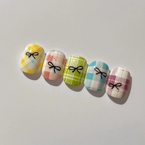 Relief bow nail art stickers featuring colorful checkered designs and black bows