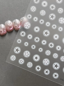 Detail of star pattern nail stickers on semi-transparent backing for nail art decoration