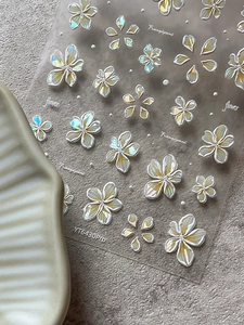 Macro shot of 3D embossed frangipani nail stickers with white pearl finish YT6430