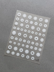 Detail view of star-shaped nail art stickers with white star patterns and YT6106 code